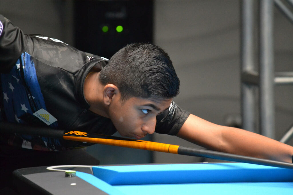 Professional billiards player concentrating and aiming precise shot at pool table wallpaper background