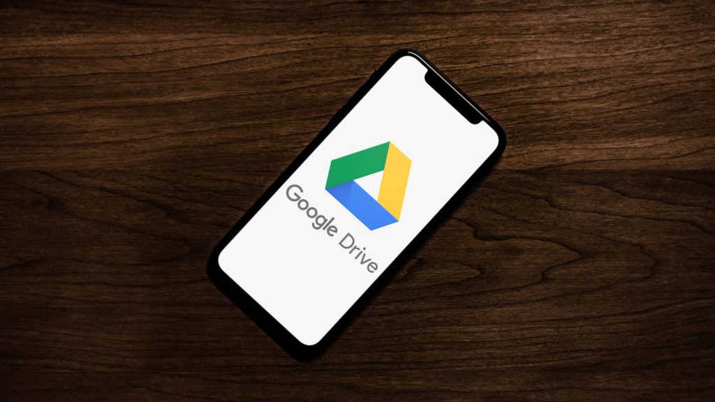 Professional smartphone wallpaper with Google Drive logo on dark wooden table background