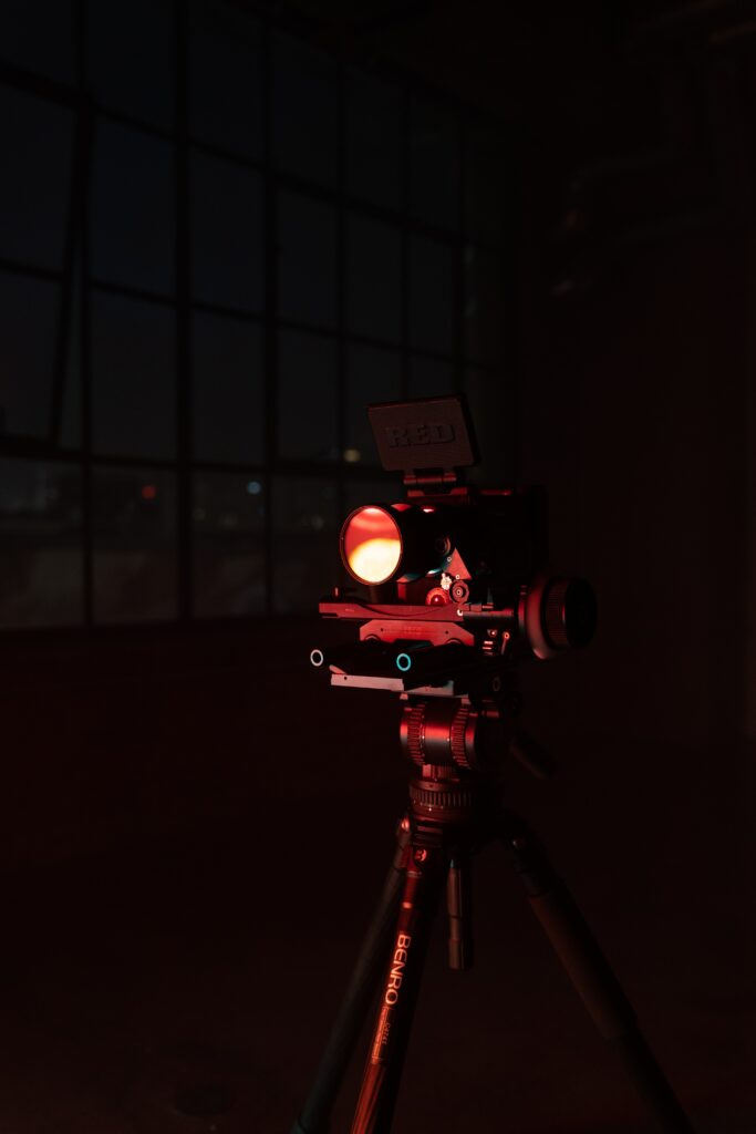 Moody Wallpaper: Professional Video Camera on Tripod in Dim Lighting