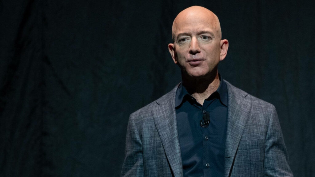 Confident Jeff Bezos Wallpaper: Professional Blazer on Black Background