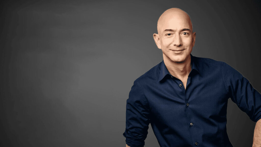 Jeff Bezos High-Quality Wallpaper in Dark Blue Shirt on Gray Background