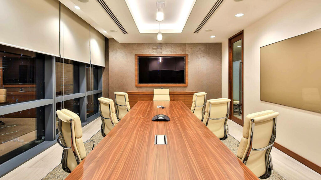 Modern conference room wallpaper with polished wooden table cream chairs and warm lighting