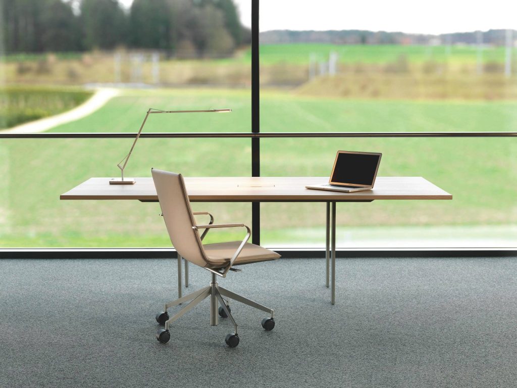 Professional Zoom background with modern office desk chair laptop and serene green landscape view Wallpaper