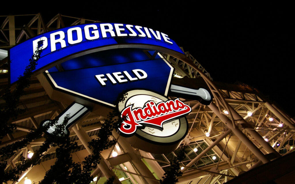 Illuminated Progressive Field entrance with Cleveland Indians logo at night cityscape wallpaper
