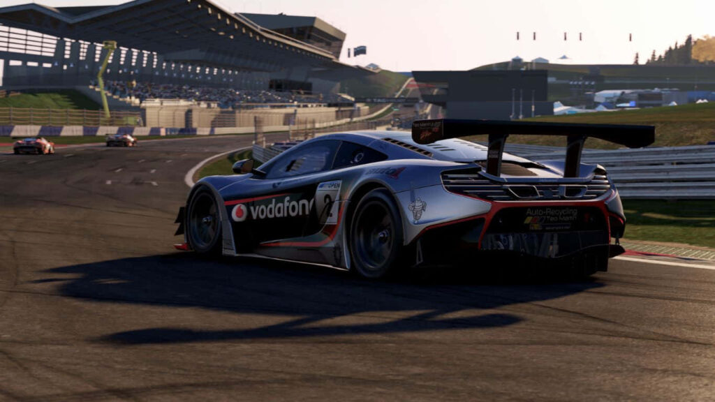 High-performance racing car speeding on sunlit track in Project Cars 2 motorsport wallpaper