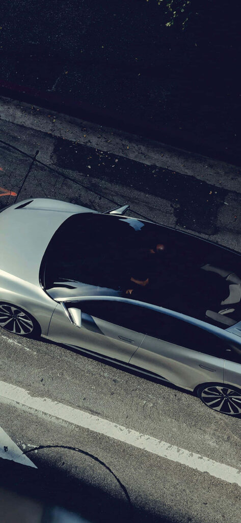 Aerial view of sleek silver sports car on urban street Project Cars 2 racing wallpaper background