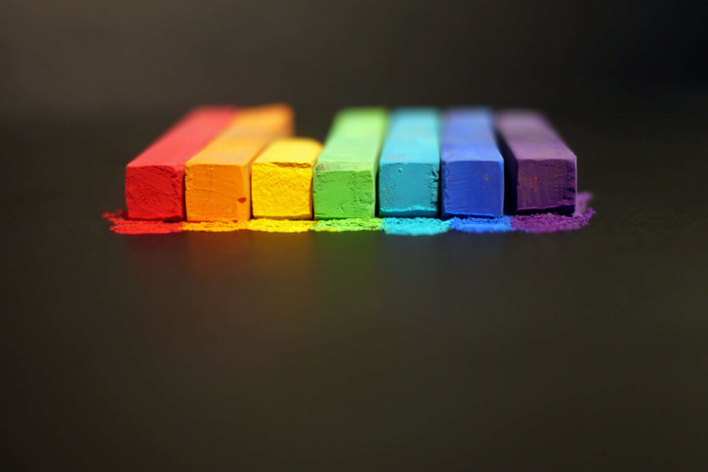 Prideful Spectrum: A Vibrant Crayon Desktop Wallpaper Against a Dark Backdrop