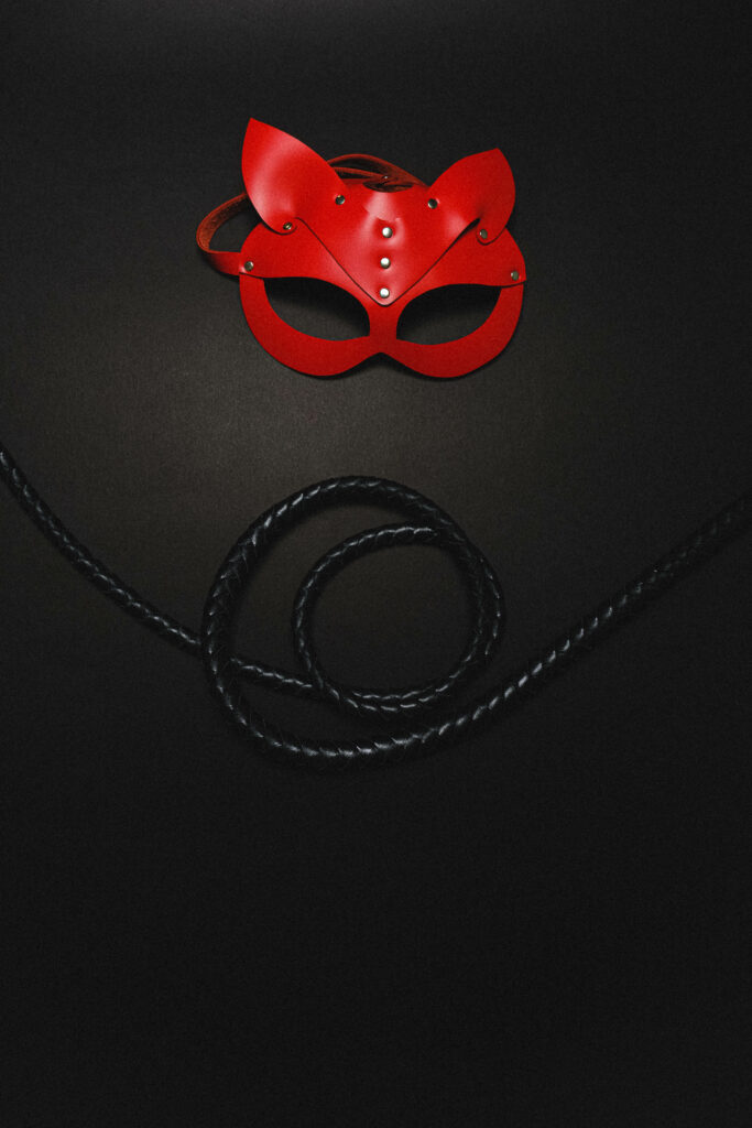 Provocative Snapshot: Red Whip and BDSM Playthings Set the Stage Wallpaper