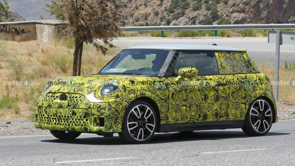 Mini car with psychedelic green yellow swirls on road against scenic outdoor background wallpaper