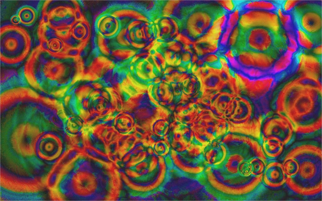 Psychedelic hippie digital art wallpaper with vibrant rainbow ripple spheres and abstract pattern