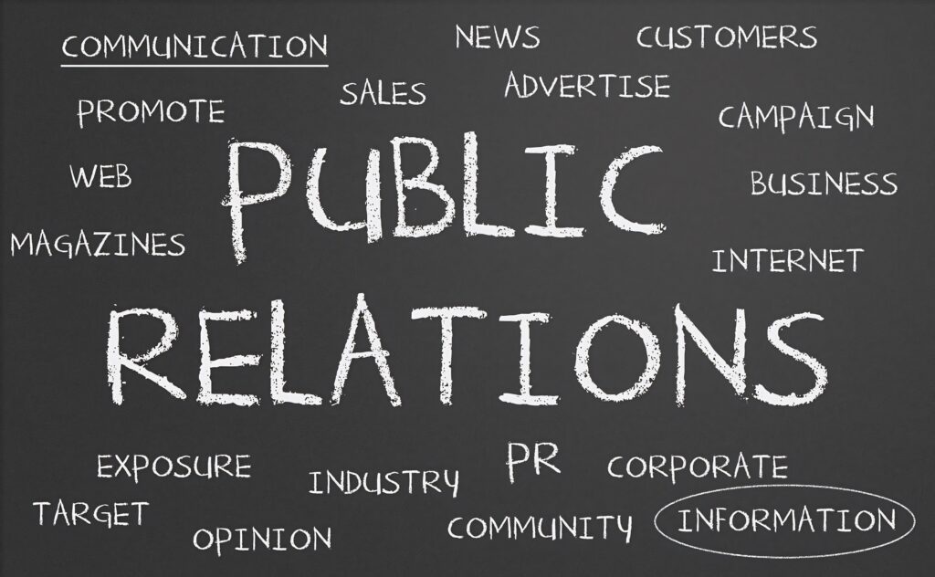 Chalkboard wallpaper with Public Relations phrase and key PR terms communication news customers