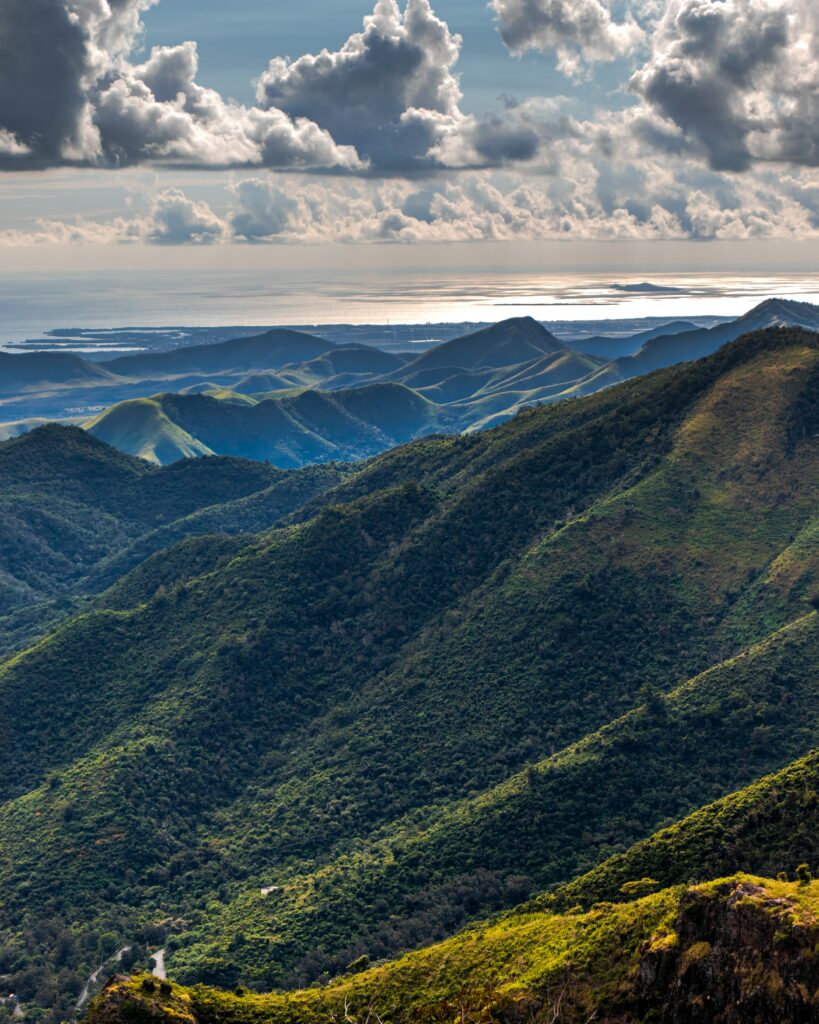 Lush green hills and dramatic Puerto Rico mountains under textured sky with coastal view wallpaper