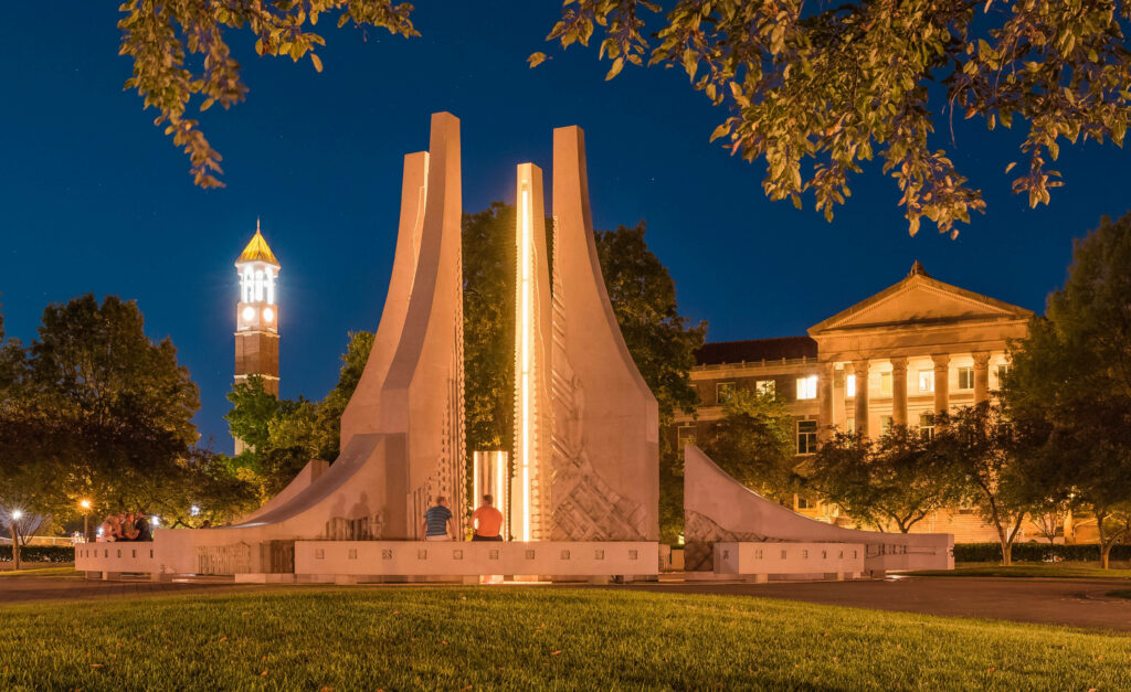 Purdue University Engineering Fountain illuminated at night with vibrant lights and historic campus Wallpaper