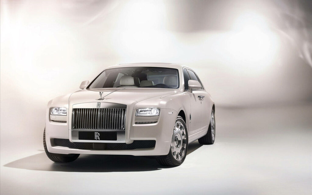Pearl Perfection: Stunning Side View of The Rolls Royce in White Showroom Wallpaper