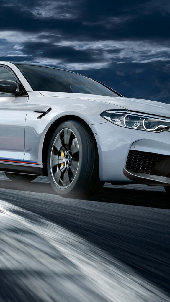 Pure white BMW M8 racing on track in 4K motion with dramatic cloudy sky sleek wallpaper background