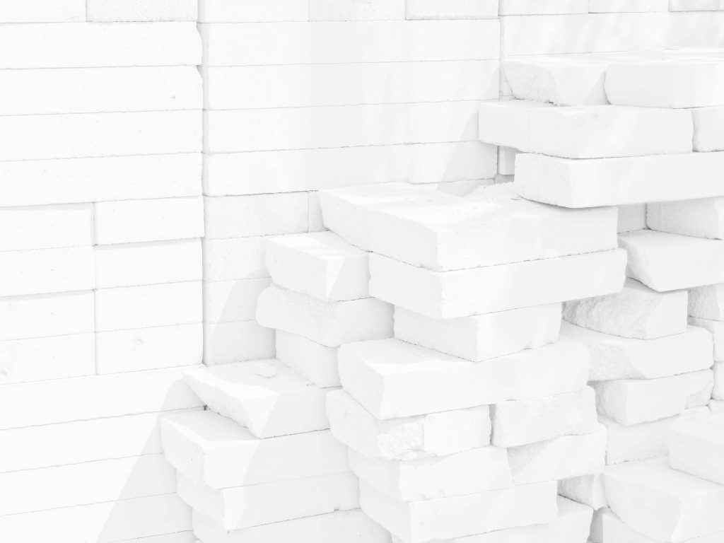 Pure white bricks stacked against white wall modern minimalist textured wallpaper background