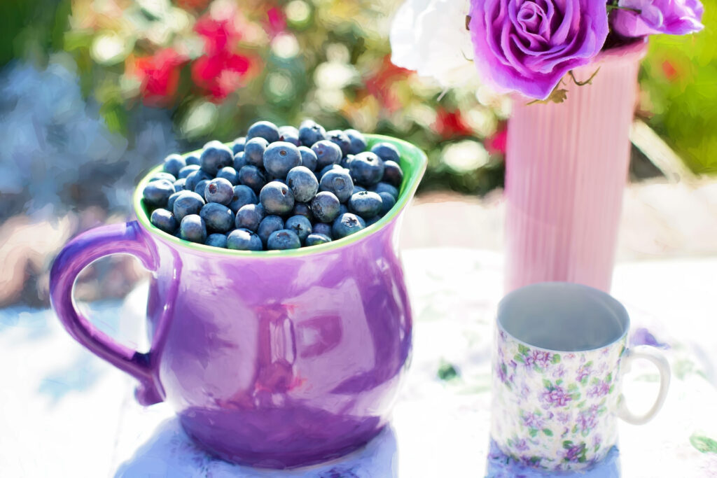 Purple ceramic jug overflowing with fresh blueberries floral wallpaper background vibrant colors