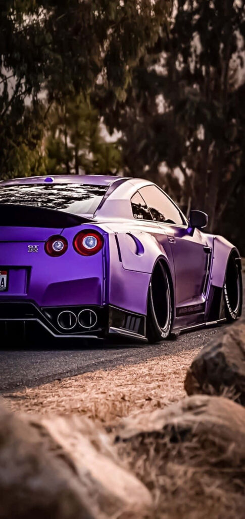 Purple Nissan R35 GTR wide body kit parked on scenic road with trees rocks aggressive stance Wallpaper