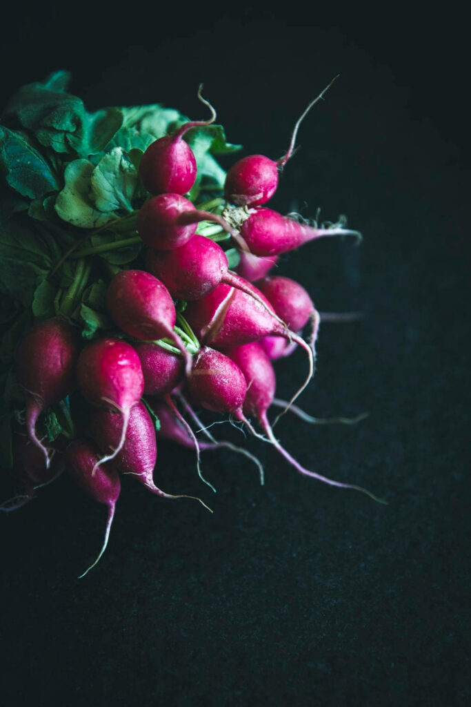 Vibrant Radish: A Captivating Mobile Wallpaper Set Against a Dark Canvas