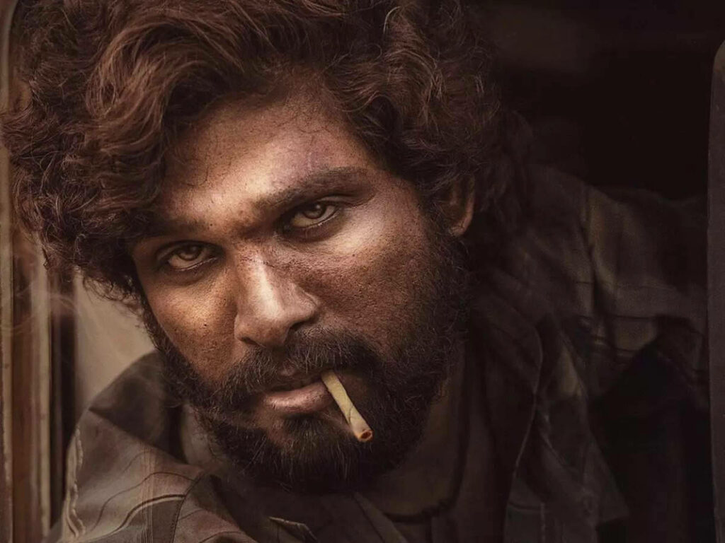 Closeup of Allu Arjun as Pushpa with intense eyes and cigarette showcasing rugged fierce look wallpaper