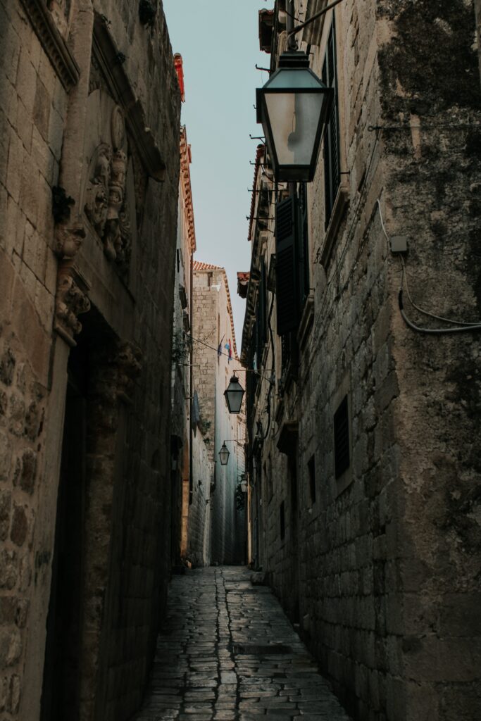 Charming Old City Lane Wallpaper: Rustic Stone & Vintage Lanterns