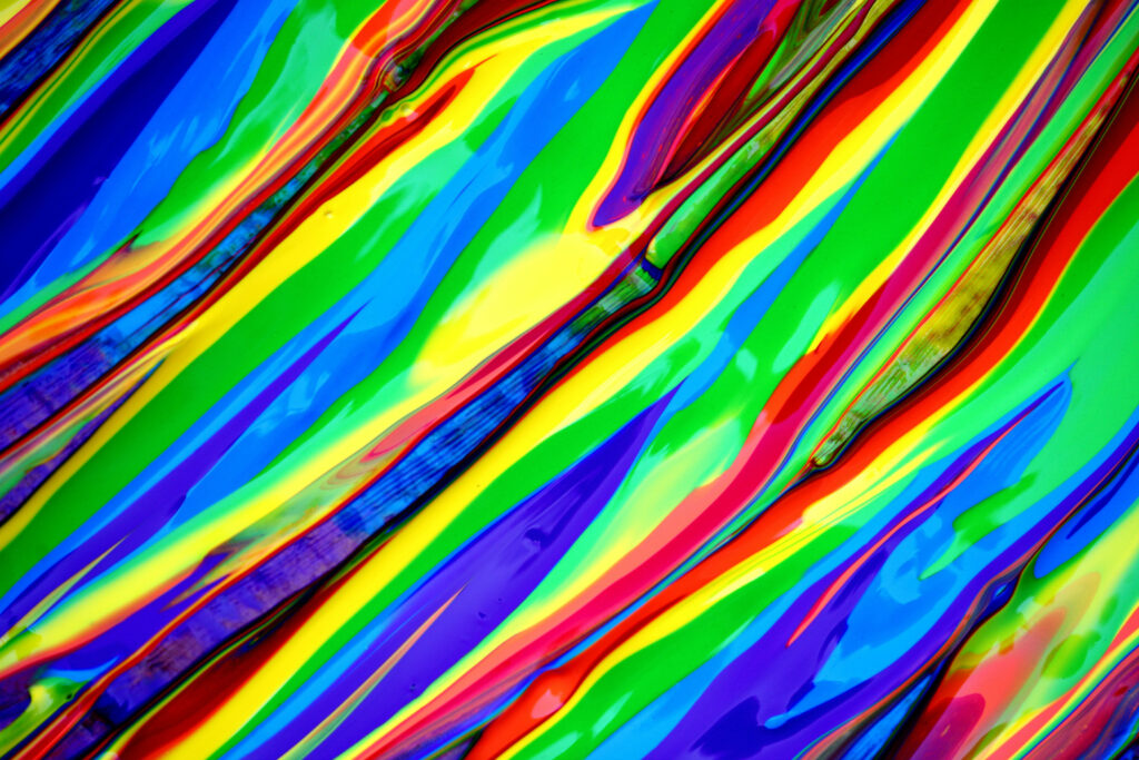 Glossy multicolored thick paint strokes fluid art vibrant abstract wallpaper background design