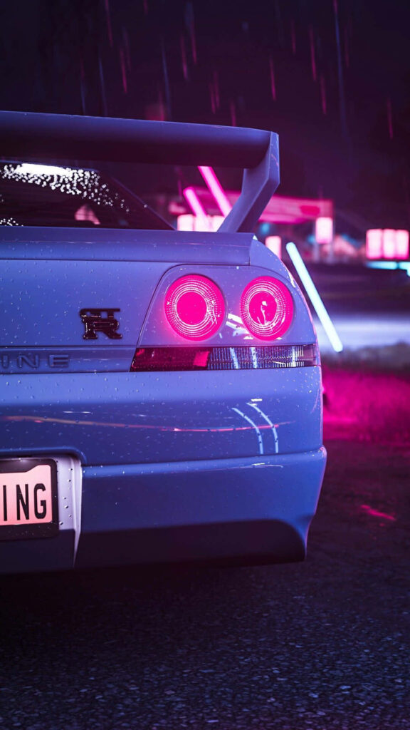 Rear view of R33 GTR with neon pink lights and spoiler against glowing city neon reflections wallpaper