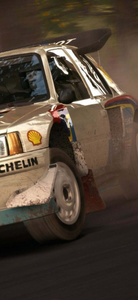 Speedy Dirt Rally Car Cornering Close-up - High Energy Racing Wallpaper