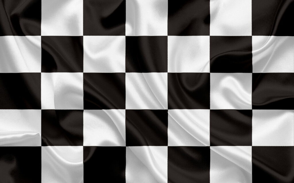 Thrilling Victory: A Stunning Checkered Flag Triumph Graced by Monochrome Silk Flags Wallpaper