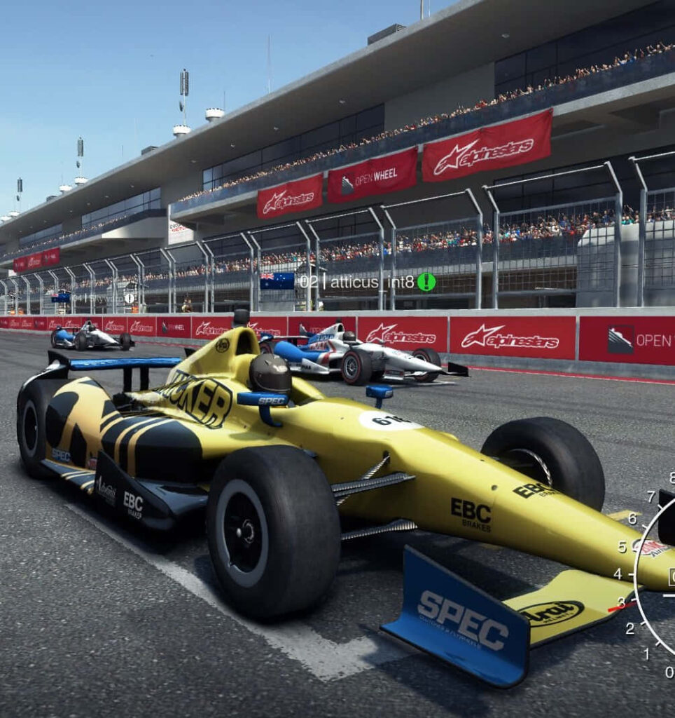 Zooming Through the Grid: Vibrant Yellow Open Wheel Car Races at the Track Amidst Grid Autosport Background Wallpaper