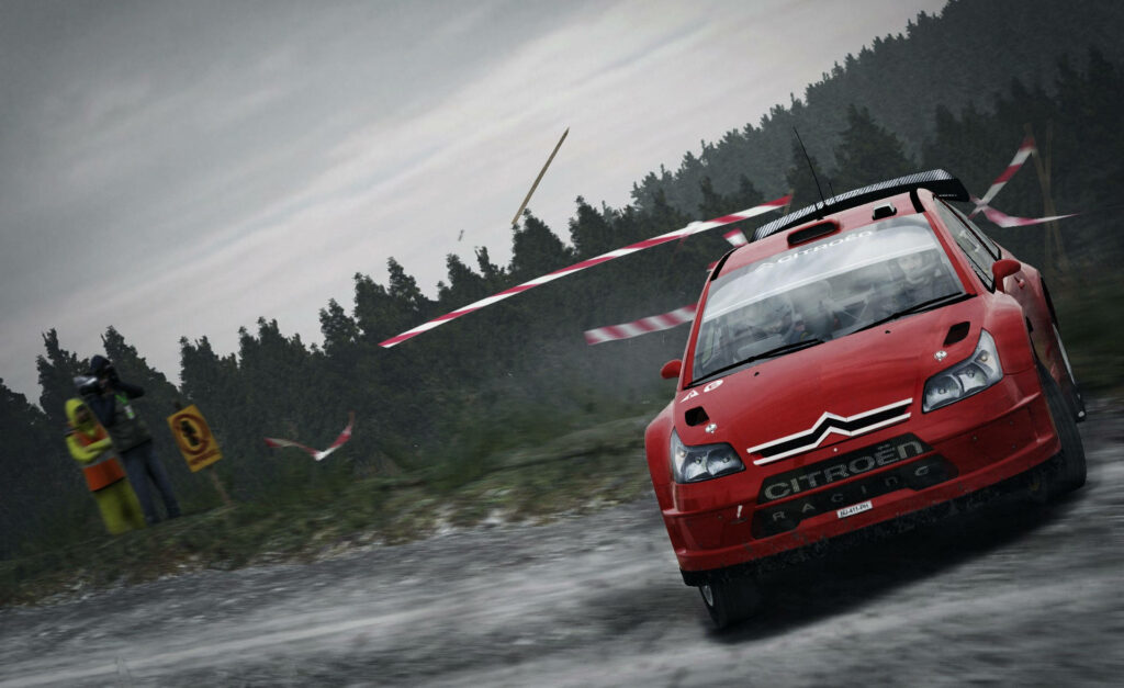 Thrilling Action: Red Citroën Car Drifting through Challenging Terrain in 'Dirt Rally' Wallpaper
