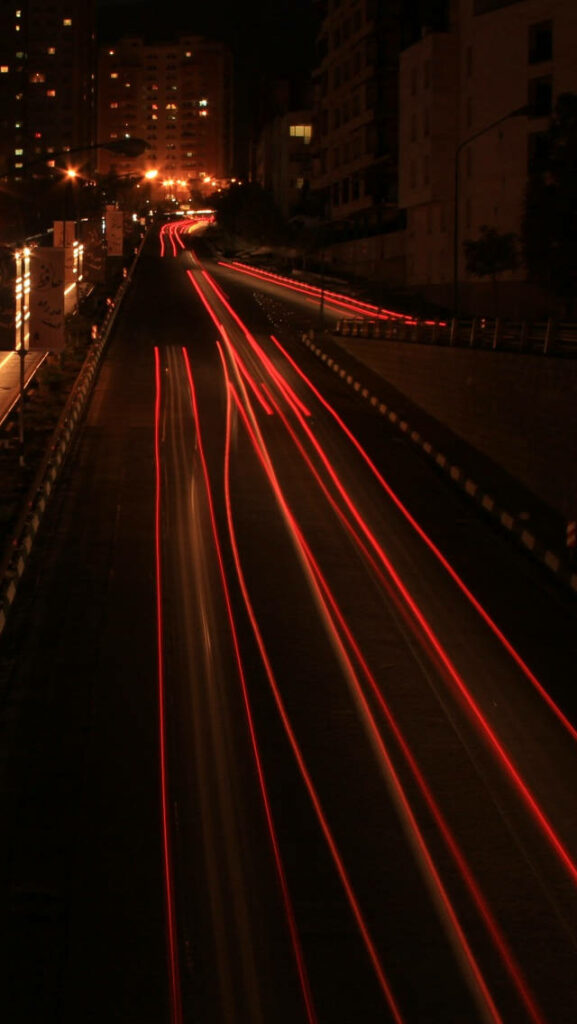 Lightning-Fast Traffic Rushing along an iPhone Highway - Speed-themed iPhone Wallpaper