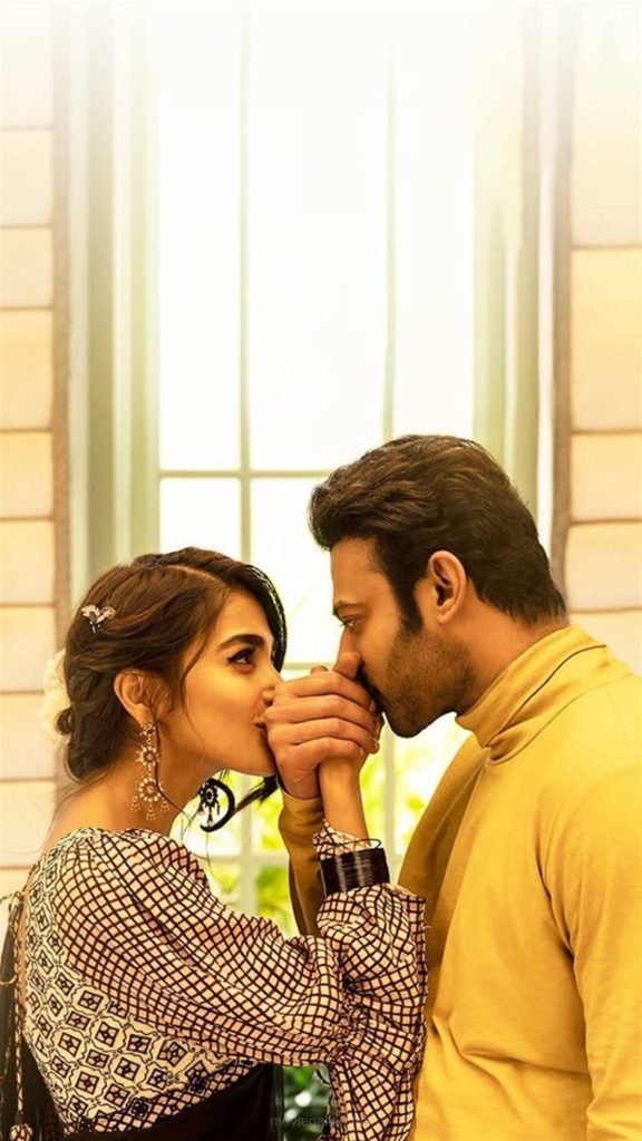 Prabhas kisses Pooja Hegde’s hand in Radhe Shyam romantic glowing window light wallpaper