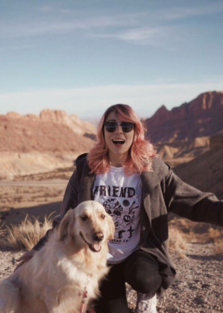 Amy Nelson smiling outdoors with happy golden retriever vibrant joyful wallpaper background