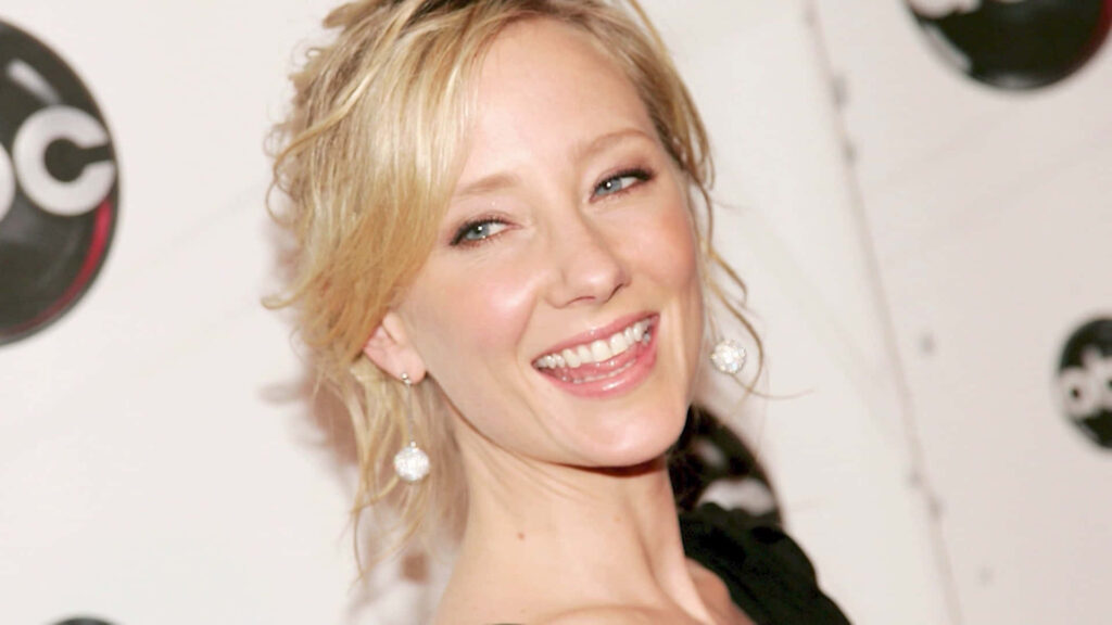 Anne Heche smiling with styled blonde hair bright ABC logo background radiant wallpaper