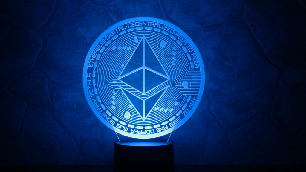 Radiant blue Ethereum trophy glowing on textured stone with digital text and futuristic design Wallpaper