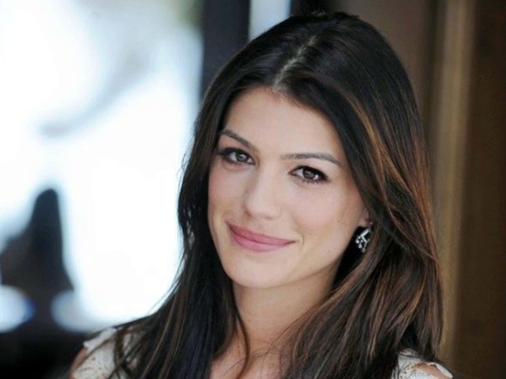 Genevieve Padalecki smiling portrait with dark hair elegant earrings soft lighting wallpaper background