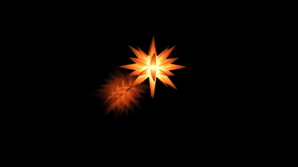 Radiant Golden Star Wallpaper with Angular Points on Dark Background