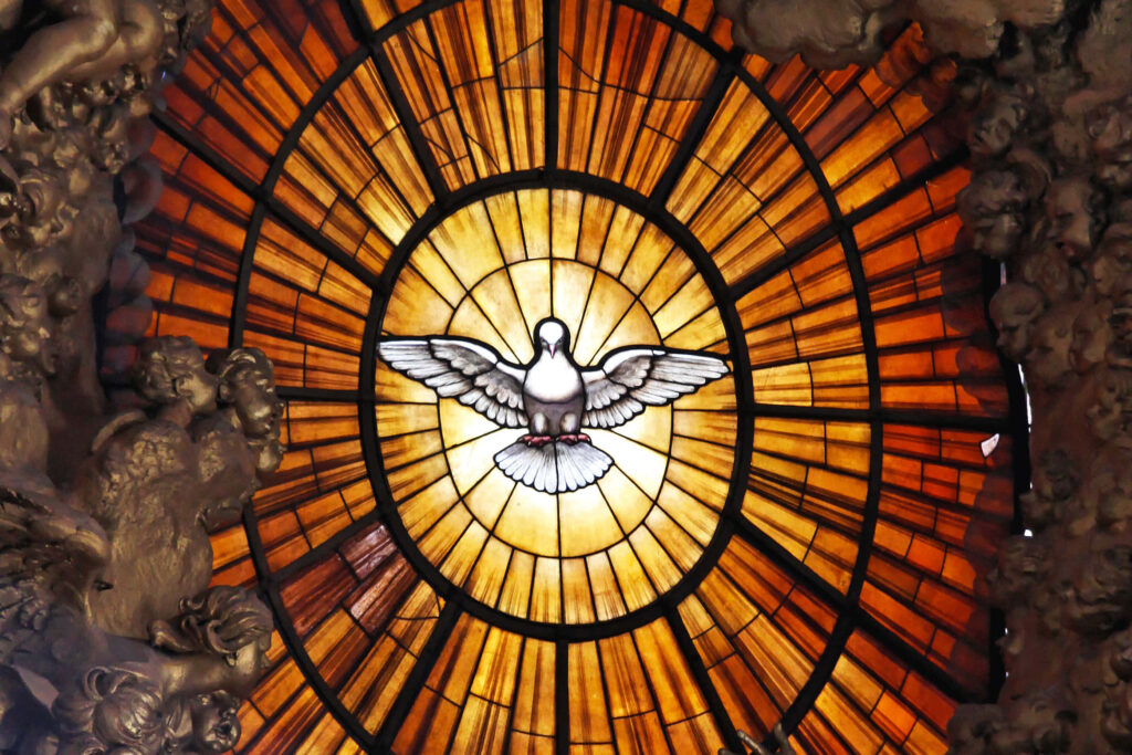 Radiant light rays through stained glass with central dove and angel statues wallpaper background