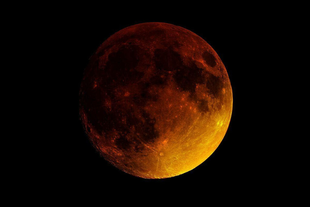 Radiant Lunar Eclipse Wallpaper: Deep Red & Orange Against Black