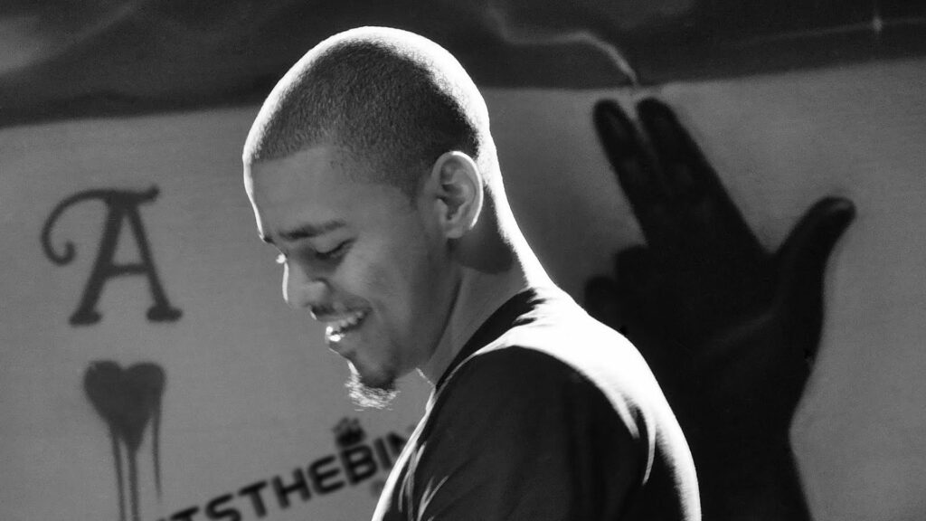 Joyful J Cole: Vibrant HD Wallpaper of a Smiling Rapper