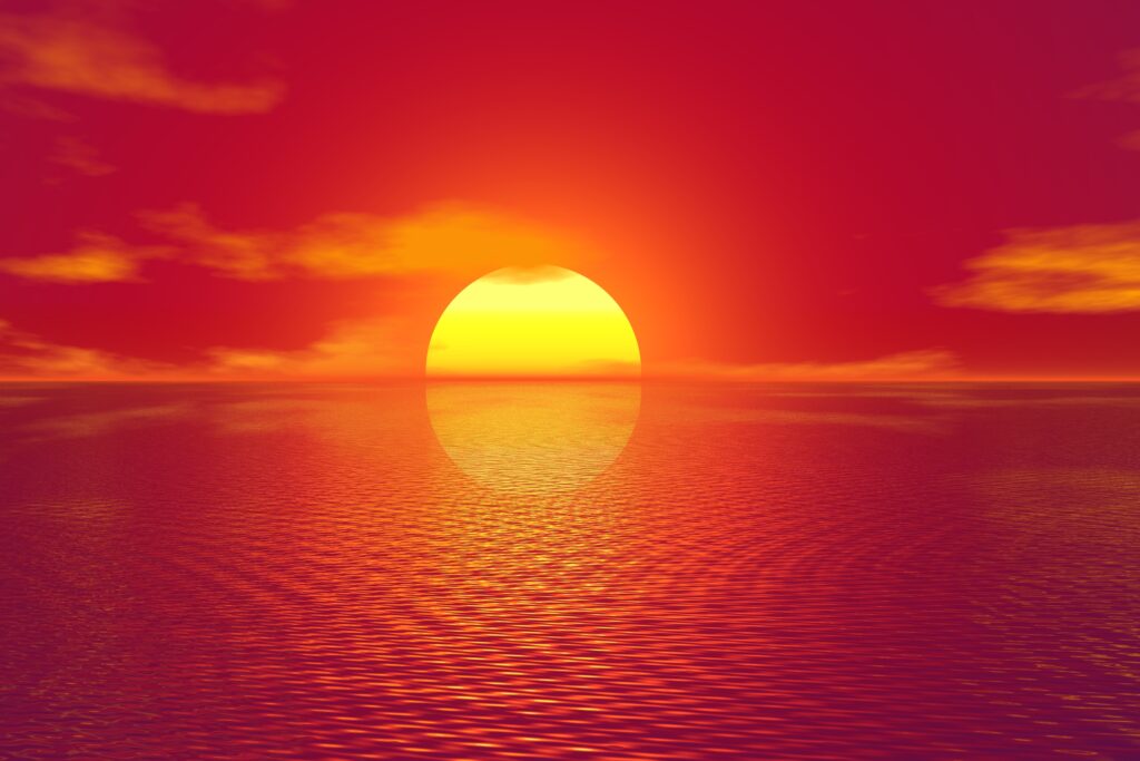 Radiant sunset over rippling water with warm yellow and orange hues vibrant calming wallpaper background