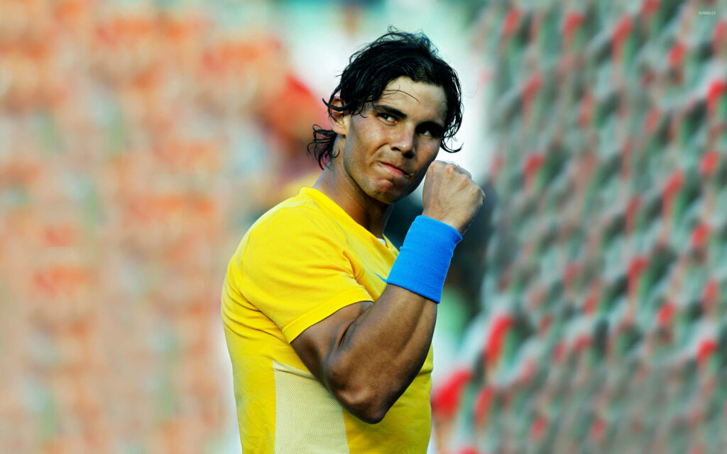 Rafael Nadal's Intense Fist Pump: Vibrant Wallpaper Background