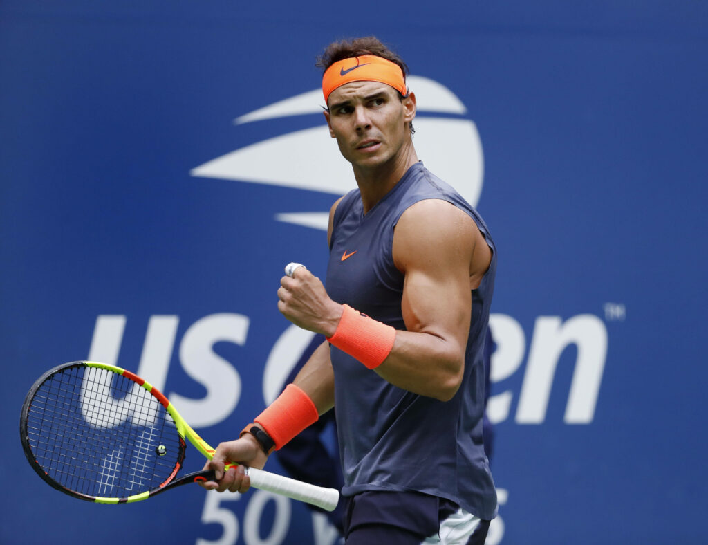 Rafael Nadal's Intense Fist Pump: Dynamic Tennis Wallpaper Background