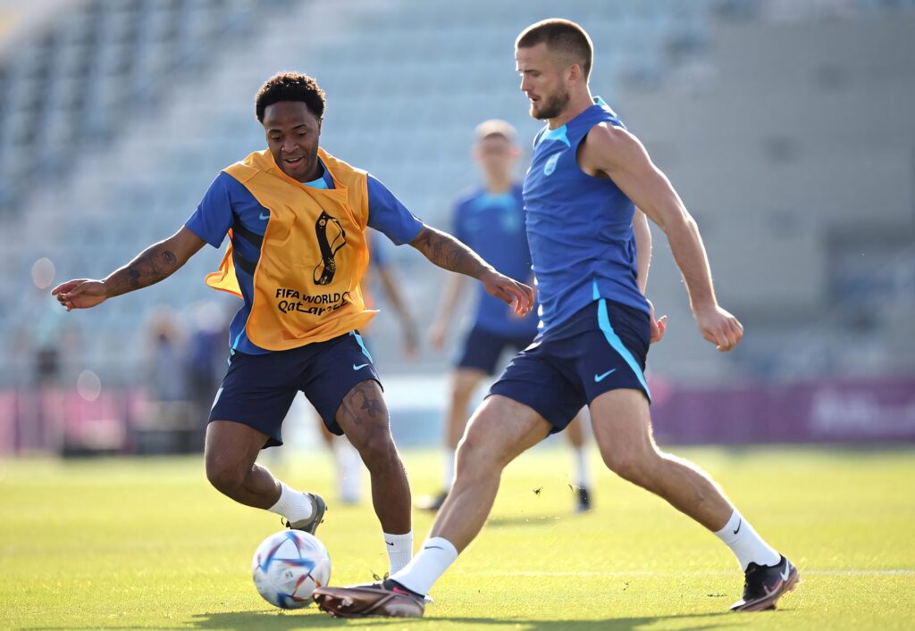 Raheem Sterling and Eric Dier focused on ball during intense football training in sunny stadium Wallpaper