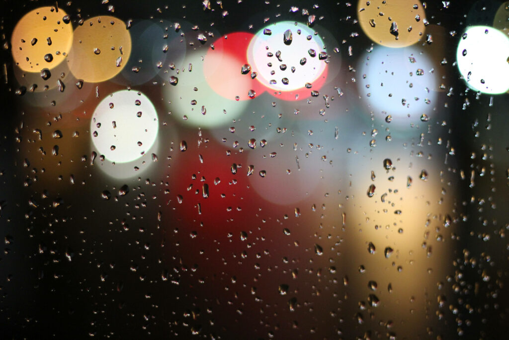Rain-Kissed Window: A Captivating Lock Screen with Bokeh-Lit Exquisiteness Wallpaper