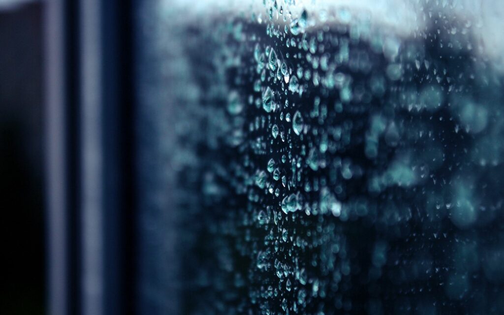 Calming Rain Droplets on Glass: Sharp Detail Wallpaper Background