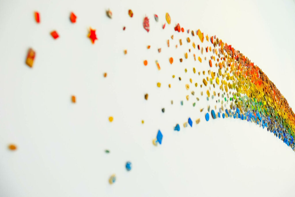 Vibrant rainbow beads scattered on white background colorful minimalist wallpaper design