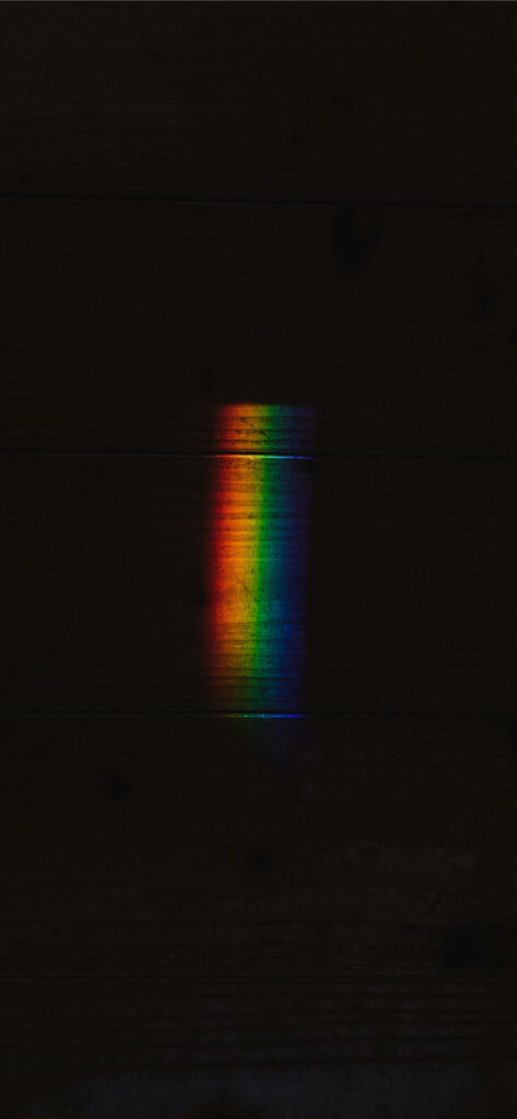 Dazzling Color Symphony: A Mesmerizing Rainbow Refraction on Black Apple iPhone Wallpaper