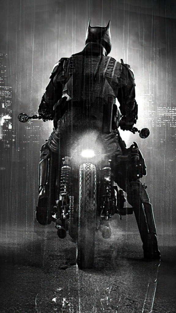 The Dark Knight Rides: Batman's Batmobile Motorcycle Braving the Rain in Striking Monochrome Wallpaper